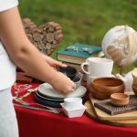 Woman,holding,beautiful,bowls,near,table,with,different,items,on