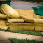Couch,placed,by,curbside,next,to,garbage,can,on,bulk