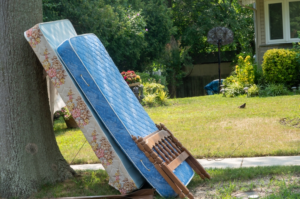 An,old,mattress,,box,spring,and,wooden,frame,by,a